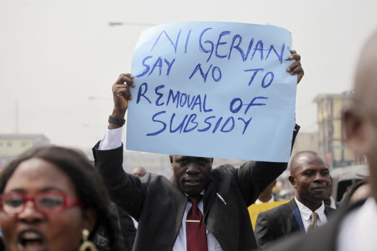 A member of the Nigerian Bar Association holds up a placard to protest a fuel subsidy removal in Lagos