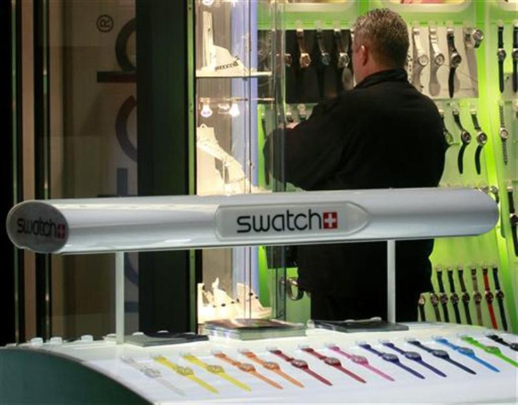 A man stands at a Swatch watch store at Zurich central station