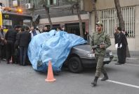 Mostafa Ahmadi-Roshan's car is lifted from the scene after it was blown up by a magnet bomb in Tehran