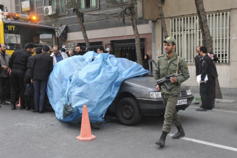 Mostafa Ahmadi-Roshan's car is lifted from the scene after it was blown up by a magnet bomb in Tehran