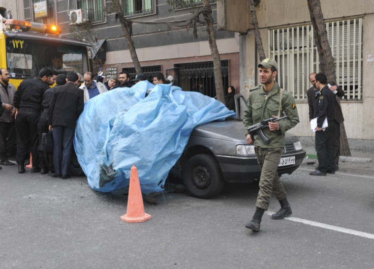 Mostafa Ahmadi-Roshan's car is lifted from the scene after it was blown up by a magnet bomb in Tehran