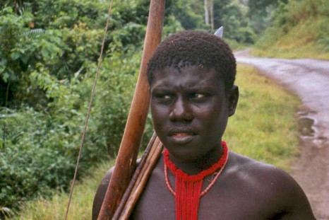 A tribal man with his bow looks on at the Andaman Trunk road in Jarawa reserve