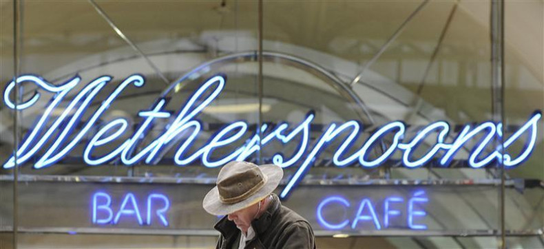A Wetherspoon&#039;s logo is seen at a bar in central London