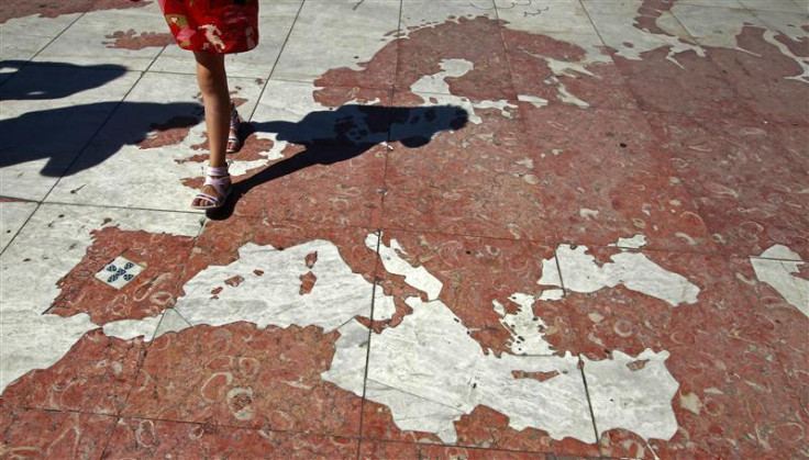 A woman walks on a map of Europe, which is part of a marble world planisphere, in Lisbon August 14, 2011.