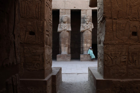 Temple guardian sits in Karnak Temple in Luxor