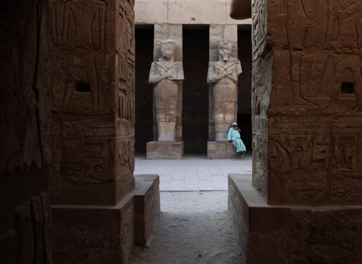 Temple guardian sits in Karnak Temple in Luxor