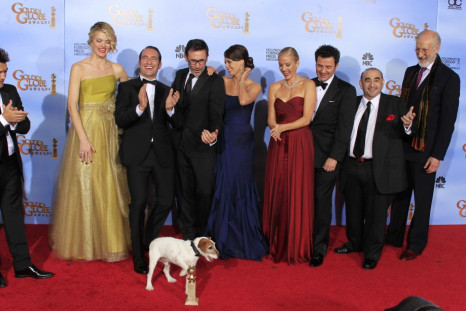 The cast, director and producer of "The Artist," winner of the award for best motion picture - comedy or musical, pose backstage at the 69th annual Golden Globe Awards in Beverly Hills (Reuters)