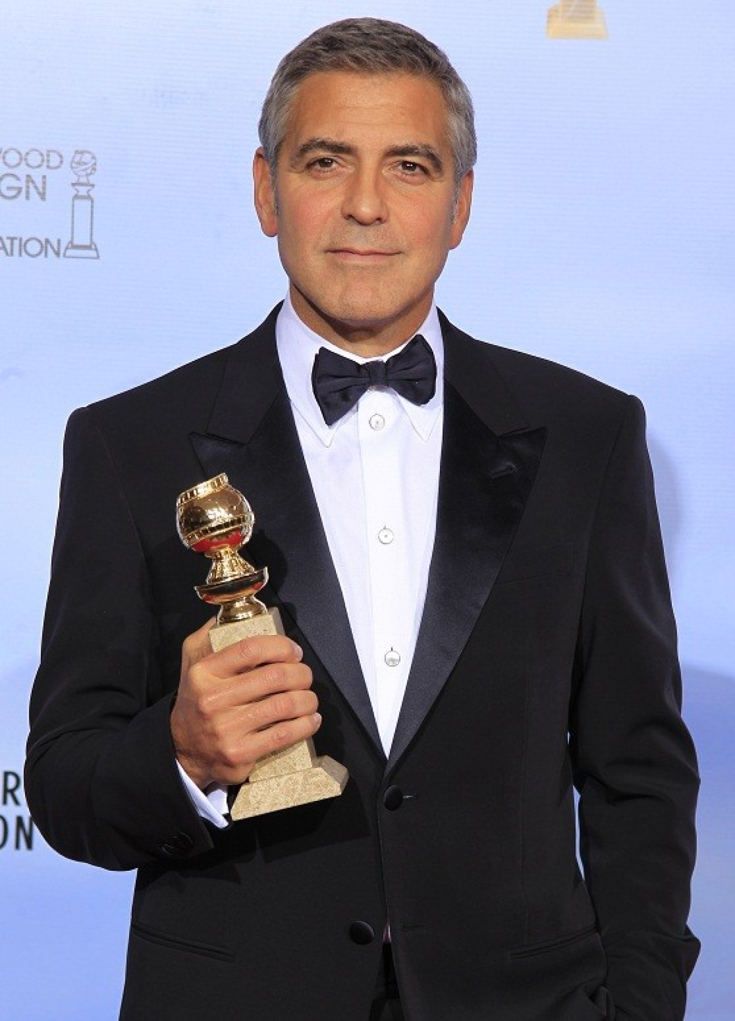 George Clooney poses with his award for best actor in a motion picure - drama for "The Descendants," backstage in Beverly Hills (Reuters)