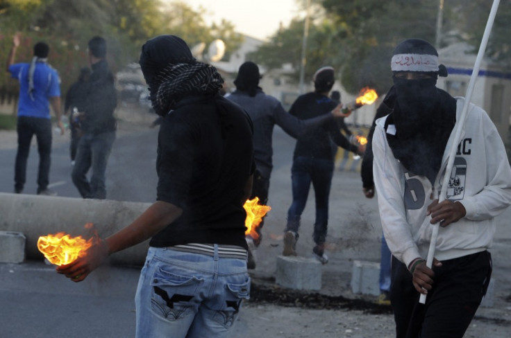 Anti-government protesters hold Molotov cocktails during clashes with police in the village of Barbar