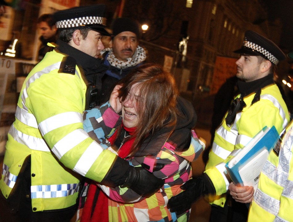 Police move a woman during the Parliament Square eviction