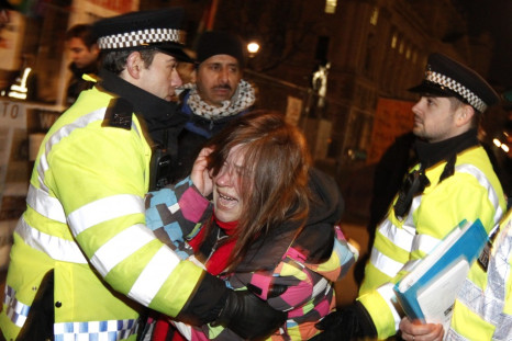 Police move a woman during the Parliament Square eviction