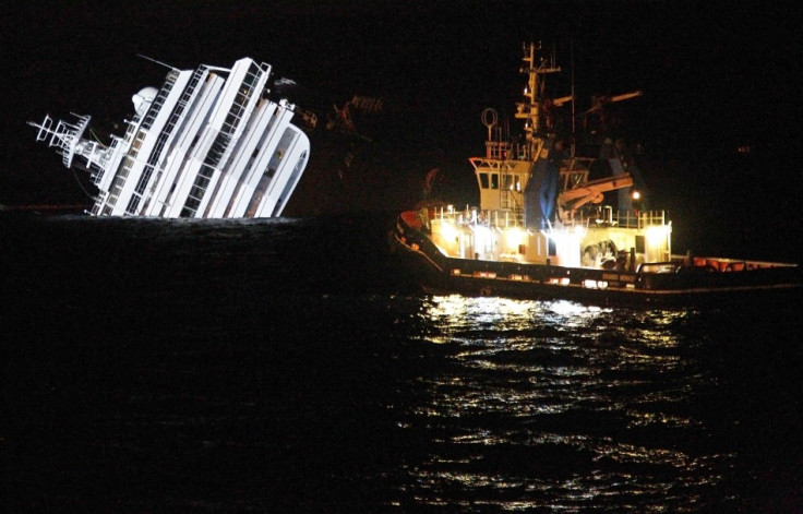 An oil removal ship is seen next to the Costa Concordia cruise ship