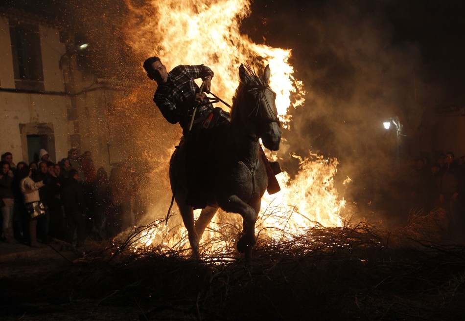 A man races through the flames during the annual Luminarias festival in Spain