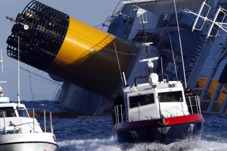 A boat with rescue workers is seen near the Costa Concordia cruise ship