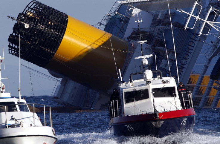 A boat with rescue workers is seen near the Costa Concordia cruise ship