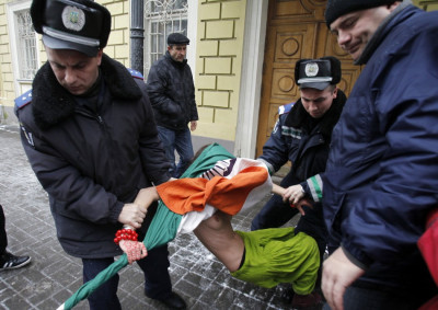 Another activist from Femen is detained by police during the protest, held in temperatures of -5C Another activist from Femen is detained by police during the protest, held in temperatures of -5C