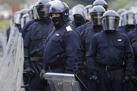 A police riot squad arrives at the low security Ford Open Prison in Arundel, southern England