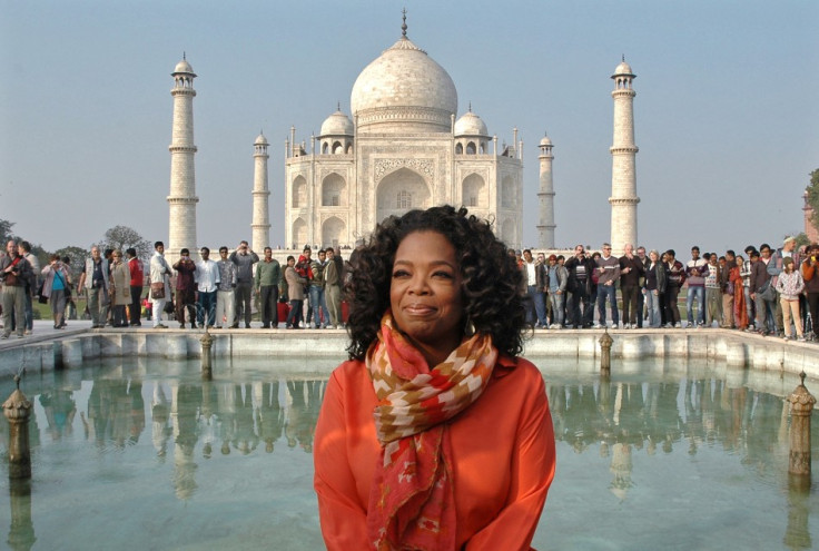 Chat show host Oprah Winfrey poses outside the Taj Mahal in Agra during her fist visit to India