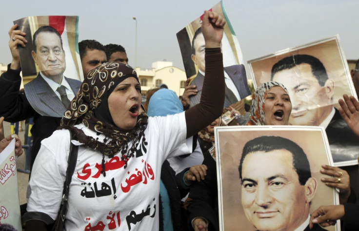 Supporters of Egypt's former President Hosni Mubarak shout slogans outside the police academy in Cairo