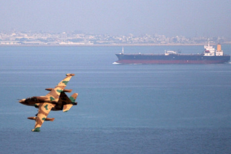 Iranian military fighter plane flies past oil tanker during naval manoeuvres in Persian Gulf and Sea of Oman