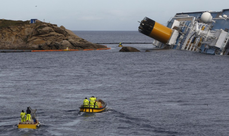 Oil recovery workers head towards the Costa Concordia cruise ship