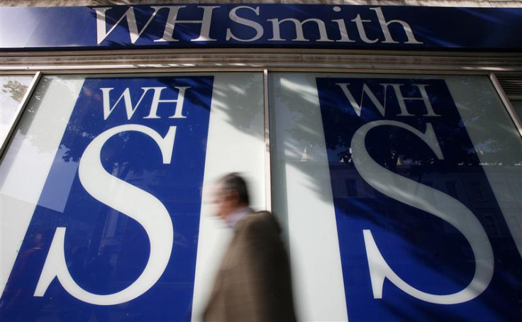 Pedestrians walk past a WH Smith shop in London