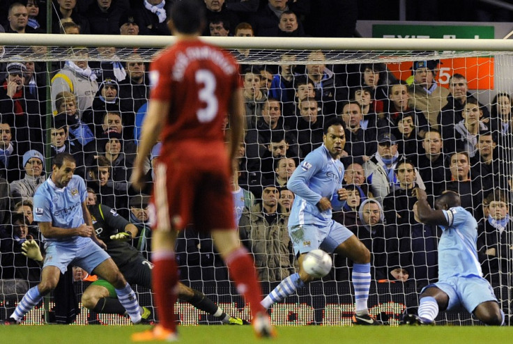 Manchester City&#039;s Richards handles the ball to award a penalty to Liverpool during their English League Cup semi-final soccer match at Anfield in Liverpool