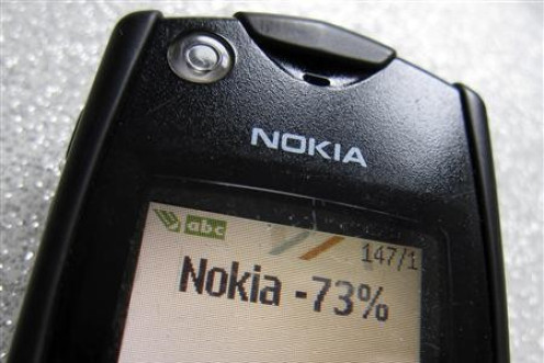 A text message of the Q4 Nokia results is seen on the screen of an early Nokia mobile phone in this photo illustration taken in Paris January 26, 2012.