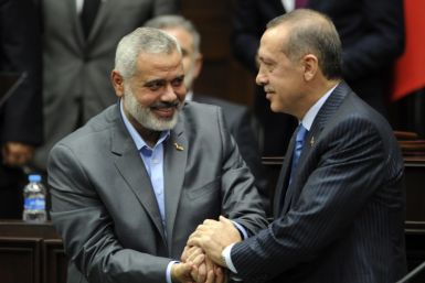 Turkey's Prime Minister Recep Tayyip Erdogan and Hamas' Gaza leader Ismail Haniyeh shake hands
