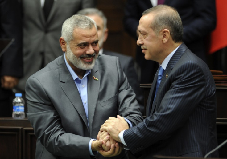 Turkey's Prime Minister Recep Tayyip Erdogan and Hamas' Gaza leader Ismail Haniyeh shake hands