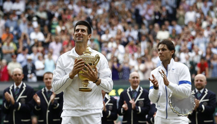 Djokovic of holds the winner’s trophy after defeating Nadal of in the men's singles final at the Wimbledon tennis championship (Reuters)