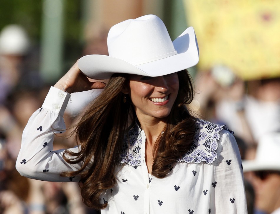 Catherine, Duchess of Cambridge, adjusts her cowboy hat as she attends a Canadian government reception in Calgary