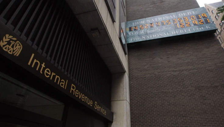 The National Debt Clock hangs on a wall next to an office for the Internal Revenue Service near Times Square in New York