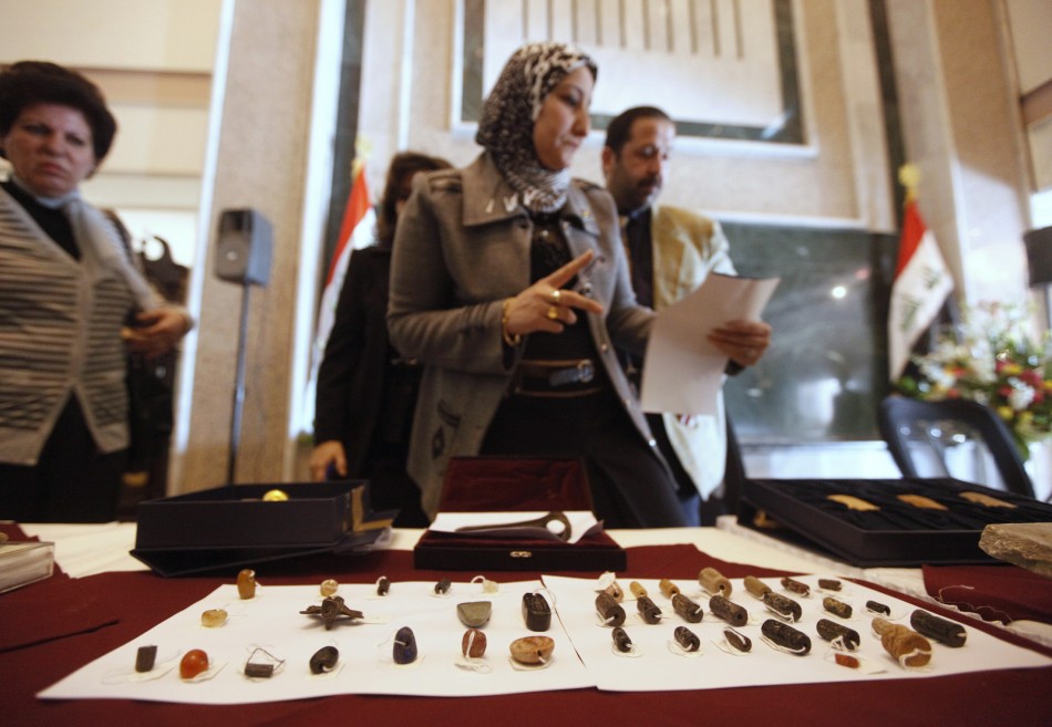 An employee checks recovered artefacts at the Iraqi Ministry of foreign Affairs headquarters in Baghdad