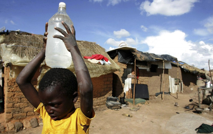 A boy carries a container of water in the suburb of Epworth in Zimbabwe's capital, Harare