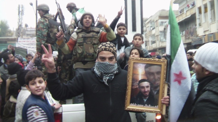 Defected Syrian soldiers are seen among demonstrators during a protest against Syria&#039;s President al-Assad in Khalidieh