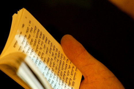 An ultra orthodox Jew holds a Torah book