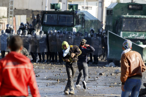 Protester throw stones at riot gendarmerie during clashes in Cheraga, on the outskirts of Algiers