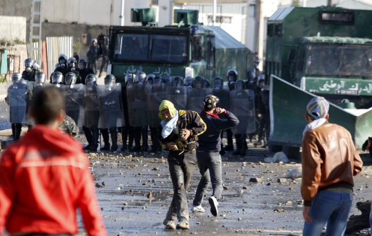 Protester throw stones at riot gendarmerie during clashes in Cheraga, on the outskirts of Algiers