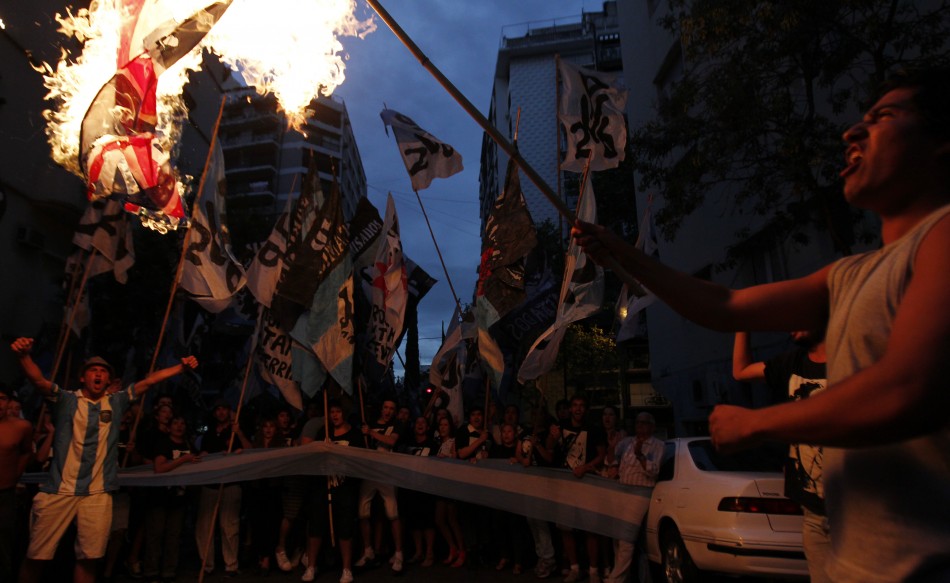 Demonstrators burn a British flag outside the British embassy