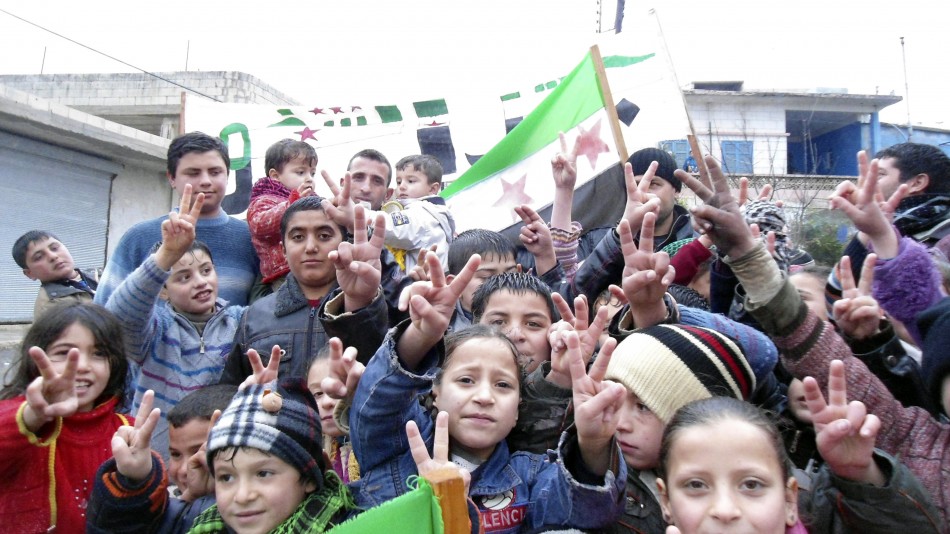 Children flash victory signs during a rally against Syrias President Bashar al-Assad in Jerjenaz, near Idlib