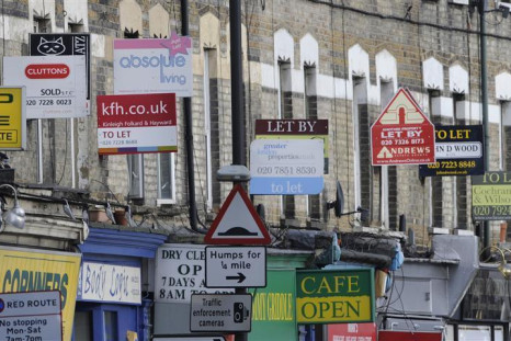 Property letting and sale signs are seen above shops in south London