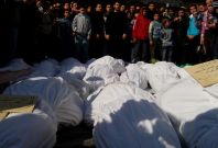 Residents attend a burial ceremony for what activists say are victims of shelling by the Syrian army