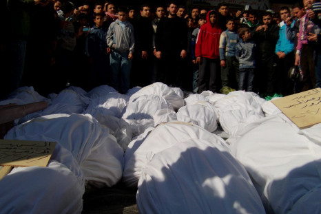 Residents attend a burial ceremony for what activists say are victims of shelling by the Syrian army