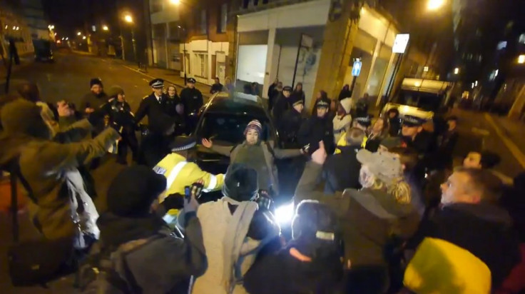 Occupy London protester tries to stop bailiff driving away from an eviction of one of their squats