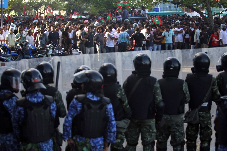 Maldivian riot police officers stand guard as they block supporters of the ousted Maldivian president Mohamed Nasheed during a clash in Male
