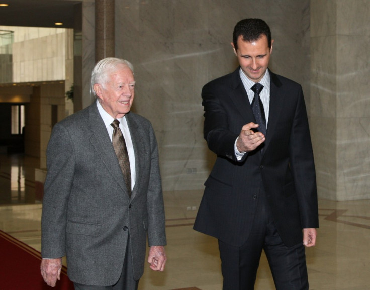 Syria's President Bashar al-Assad welcomes former U.S. President Jimmy Carter before a meeting in Damascus