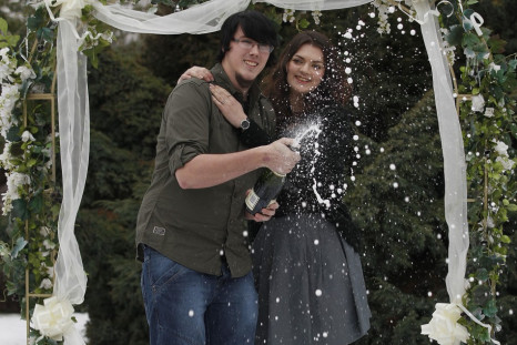 Cassey Carrington and Matt Topham pose for photographers after their £45m EuroMillions win (Reuters)