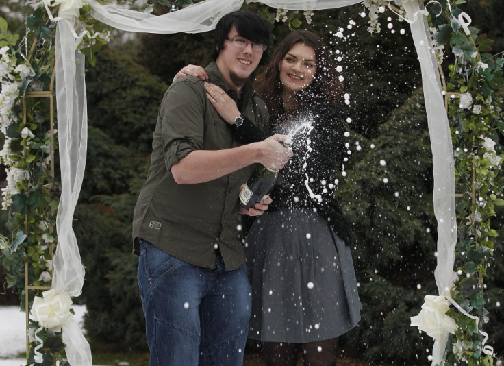 Cassey Carrington and Matt Topham pose for photographers after their £45m EuroMillions win (Reuters)