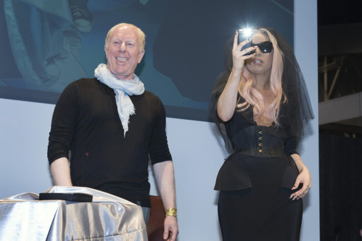 Polaroid Chairman Sager smiles as singer Lady Gaga takes photo with her mobile phone